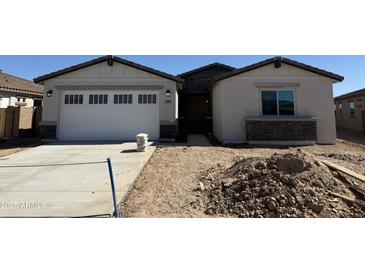 Charming single-story home with a two-car garage and stone accents offers great curb appeal at 8553 N 175Th Ln, Waddell, AZ 85355