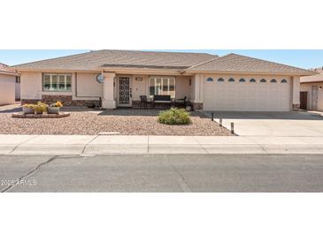 Charming single-story home features desert landscaping and a cozy front patio for relaxed outdoor living at 11413 E Neville Ave, Mesa, AZ 85209