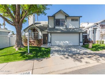 Charming two-story home featuring a two-car garage, mature landscaping, and a well-maintained front yard at 18608 N 4Th Ave, Phoenix, AZ 85027