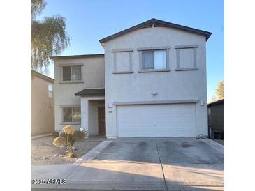 Two-story home featuring a two-car garage and low-maintenance landscaping at 2013 E Dust Devil Dr, San Tan Valley, AZ 85143