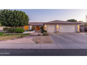 Charming single-story home featuring a two-car garage, mature landscaping, and a welcoming entrance at 2625 W Oakland St, Chandler, AZ 85224