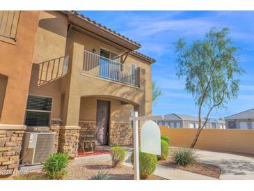 Charming two-story home featuring a balcony, stone accents, and well-manicured landscaping at 2821 S Skyline Dr # 149, Mesa, AZ 85212