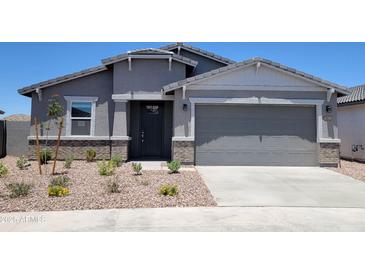 Charming single-story home with neutral stucco, brick accents, and a well-kept xeriscaped front yard at 3850 N Camden Dr, Florence, AZ 85132