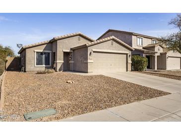 Charming single-Gathering home featuring a two-car garage and low-maintenance desert landscaping at 43556 W Colby Dr, Maricopa, AZ 85138