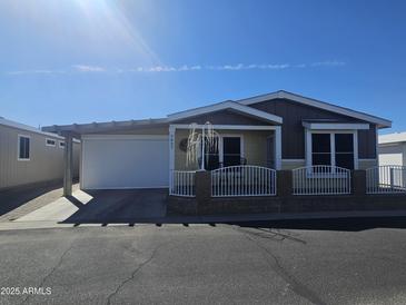 Inviting single-story home featuring a charming front porch and well-maintained landscaping at 650 N Hawes Rd # 3827, Mesa, AZ 85207