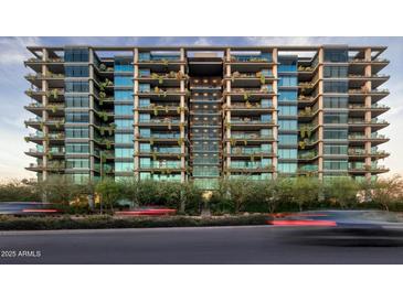 Stunning exterior view of a modern condo building with multiple balconies and lush greenery at 7120 E Kierland Blvd # 601, Scottsdale, AZ 85254