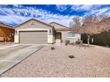 Charming single-story home showcasing a desert landscape and neutral color palette with a two car garage and tile roof at 11954 W Melinda Ln, Sun City, AZ 85373