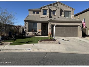 Charming two-story home featuring a desert landscape, covered entry, two-car garage, and quaint front porch at 17012 S 27Th Ln, Phoenix, AZ 85045