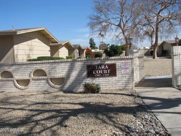 Exterior view of the Tara Court entrance sign surrounded by well-maintained landscaping at 17019 N Pinion Ln, Sun City, AZ 85373