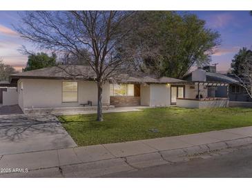 Charming single-story home featuring a well-manicured lawn and a stucco facade, capturing timeless curb appeal at 2007 S El Camino Dr, Tempe, AZ 85282