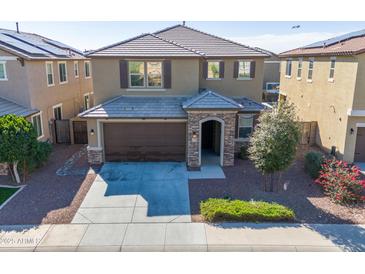 Two-story home features a manicured yard and a two-car garage at 21195 W Coronado Rd, Buckeye, AZ 85396