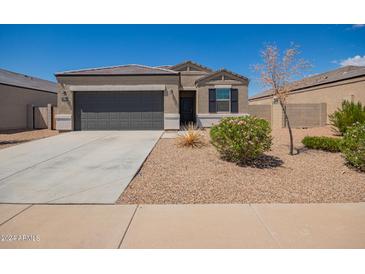 Charming single-story home with a well-manicured front yard, two car garage, and neutral colored stucco at 2420 E San Borja Trl, Casa Grande, AZ 85194