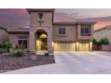 Stunning two-story home featuring stone archway, three-car garage, and well manicured landscaping at 27406 N 22Nd Ln, Phoenix, AZ 85085