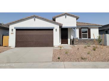 Charming single-story home featuring a two-car garage and desert landscaping in front at 3782 N Camden Dr, Florence, AZ 85132