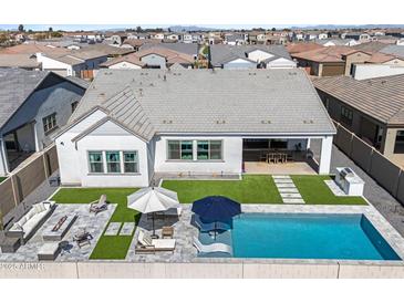 Stunning aerial view of a modern home featuring a pool, outdoor kitchen, and lush landscaping at 4097 E Tonto Pl, Chandler, AZ 85249