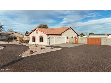 Charming single Gathering home features a large yard, two-car garage, and tile roof at 4511 S 181St Ave, Goodyear, AZ 85338