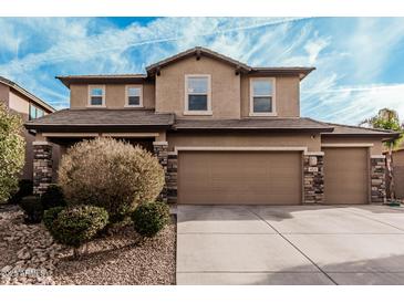 Charming two-story home with a three car garage and meticulously landscaped front yard at 4521 W Maggie Dr, San Tan Valley, AZ 85144