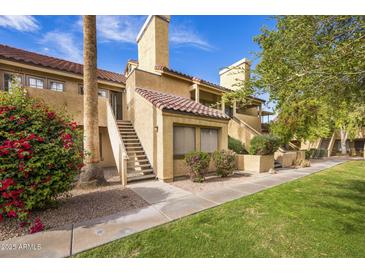 Charming condo with red tile roof, private entry stairs, desert landscaping, and bright flowering bushes at 4901 S Calle Los Cerros Dr # 264, Tempe, AZ 85282