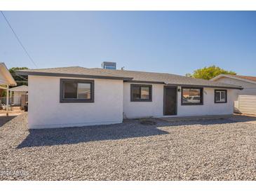 Charming single-story home featuring a neutral color scheme and low-maintenance gravel landscaping at 5731 W Morten Ave, Glendale, AZ 85301