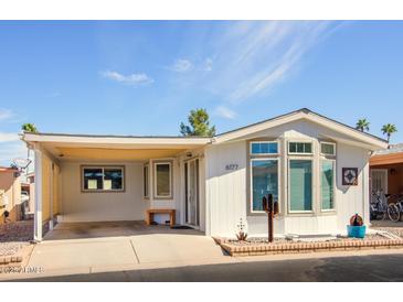 Charming home with a covered carport, desert landscaping, and a bright exterior paint scheme at 6177 S Sawgrass Dr, Chandler, AZ 85249