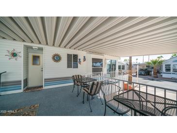 Relaxing covered patio with sun decor, seating, and outdoor charm at 624 Hawk Eye Dr, Apache Junction, AZ 85119