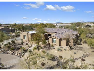 An elevated view of a desert home with a tile roof and drought-resistant landscaping at 7848 E Parkview Ln, Scottsdale, AZ 85255