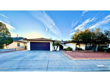 Charming single-story home featuring a two-car garage, desert landscaping and mature trees at 10008 N 50Th Dr, Glendale, AZ 85302