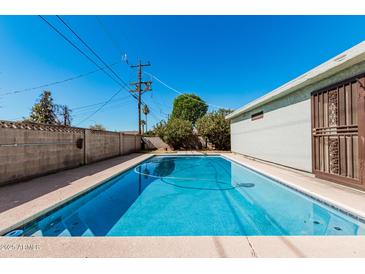 Inviting in-ground pool with clear blue water, perfect for relaxation and outdoor enjoyment at 1649 E Dana Ave, Mesa, AZ 85204