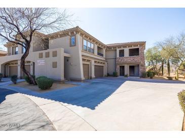 A beautiful two-story stucco condo featuring a tile roof and spacious parking area at 19700 N 76Th St # 1080, Scottsdale, AZ 85255