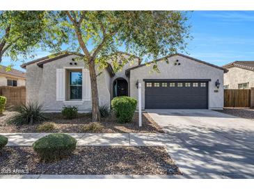 Charming single-story home featuring a two-car garage and desert landscaping at 20159 E Rosa Rd, Queen Creek, AZ 85142