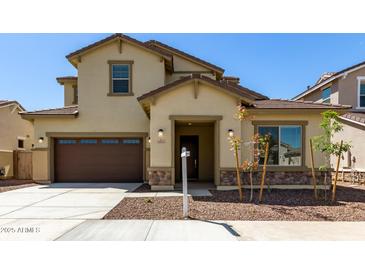 Inviting two-story home featuring a two-car garage, neutral colors, and tasteful stone accents at 20951 E Via Del Sol St, Queen Creek, AZ 85142