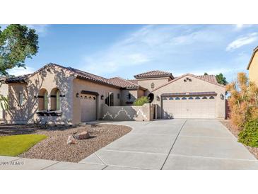 Inviting single-story home features a neutral color palette, low maintenance landscaping, and convenient three-car garage at 22722 N 120Th Ln, Sun City, AZ 85373