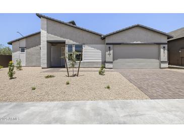 Single Gathering home features desert landscaping, gray exterior, and two car garage at 4210 E Desert Vista Trl, Cave Creek, AZ 85331