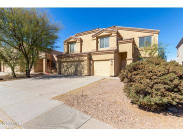 Charming two-story home featuring a three car garage and low-maintenance desert landscaping at 43608 W Kristal Ln, Maricopa, AZ 85138