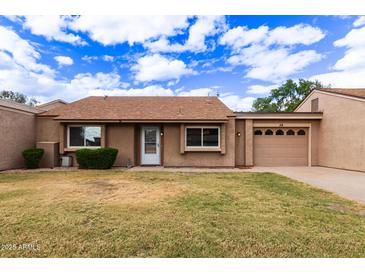 Charming single-story home featuring a well-maintained front yard and an attached single car garage at 54 Leisure World --, Mesa, AZ 85206