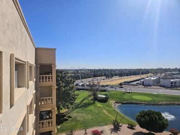 Scenic view from condo balcony overlooking lush golf course, pond, and mature trees at 7940 E Camelback Rd # 712, Scottsdale, AZ 85251