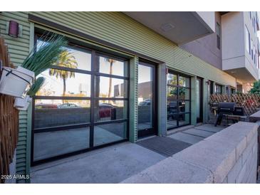 Modern townhouse with glass garage door-style openings to private patio at 1130 N 2Nd St # 103, Phoenix, AZ 85004