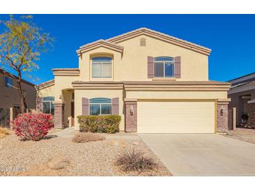 Inviting two-story home featuring a neutral color scheme, manicured landscaping, and an attached two-car garage at 1244 W Castle Dr, Casa Grande, AZ 85122