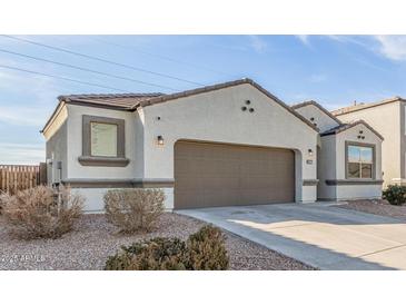 Charming single-Gathering home featuring a two-car garage and well-maintained landscaping at 3206 N 310Th Ln, Buckeye, AZ 85396