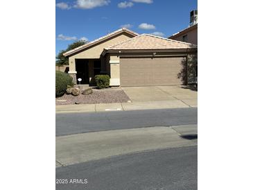 Charming single-story home featuring a well-maintained front yard and a two-car garage at 4102 E Meadow Dr, Phoenix, AZ 85032