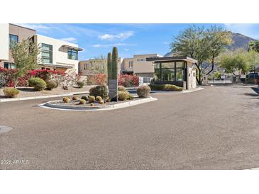 Well maintained Mountain Park community entrance featuring desert landscaping, a security booth and mountain views at 5541 E Stella Ln, Paradise Valley, AZ 85253