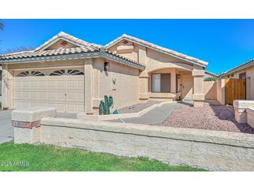 Charming single-story home with well-maintained landscaping, desert plants, and a two car garage at 5726 W Mercury Way, Chandler, AZ 85226