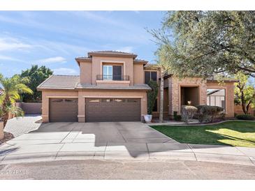 Beautiful two-story home with a three-car garage and lush landscaping at 8421 W Alex Ave, Peoria, AZ 85382