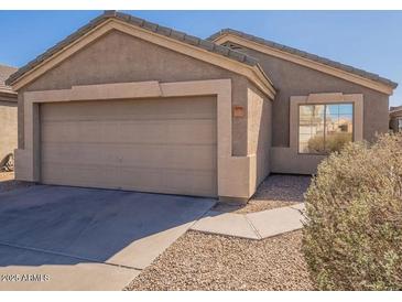 Charming single-story home featuring a two-car garage and well-maintained desert landscaping at 9705 E Butte St, Mesa, AZ 85207