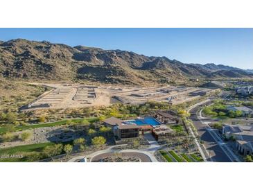 Expansive aerial view showcases new home construction with mountain views in a Primary-planned desert community at 1115 E Mcneil St, Phoenix, AZ 85042