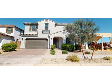 Charming two-story home with a well-manicured front yard and a two-car garage, near a neighborhood playground at 14420 W Faye Way, Surprise, AZ 85387