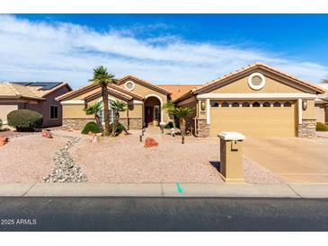 Charming single-story home boasts a well-manicured desert landscape and a spacious two-car garage at 15492 W Whitton Ave, Goodyear, AZ 85395