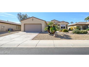 Charming single-story home featuring a two-car garage and desert landscaping at 16949 W Oasis Springs Way, Surprise, AZ 85387