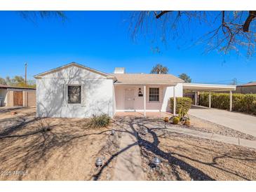 Charming single-story home with a light-colored exterior and a convenient covered carport at 1716 W Weldon Ave, Phoenix, AZ 85015