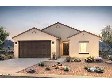 Charming single-story home featuring a two-car garage and desert landscaping at 24653 W Concorda Dr, Buckeye, AZ 85326